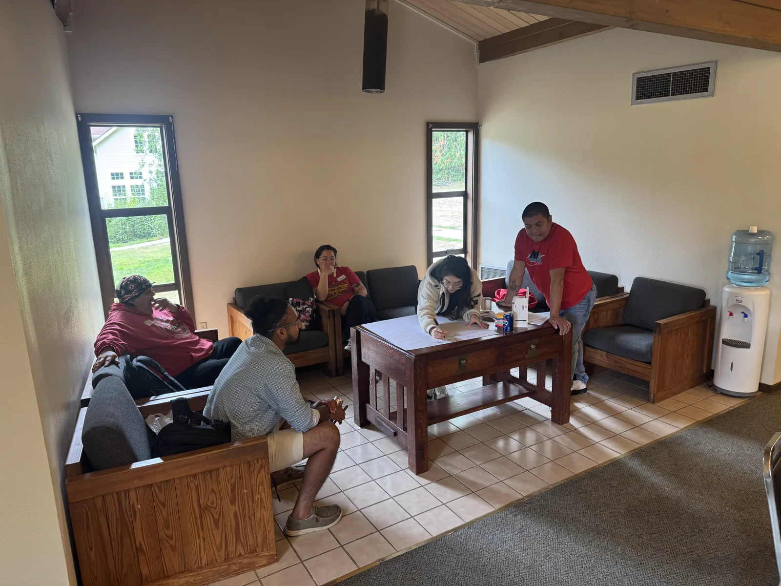 A small group of colleagues developing ideas together around a table.