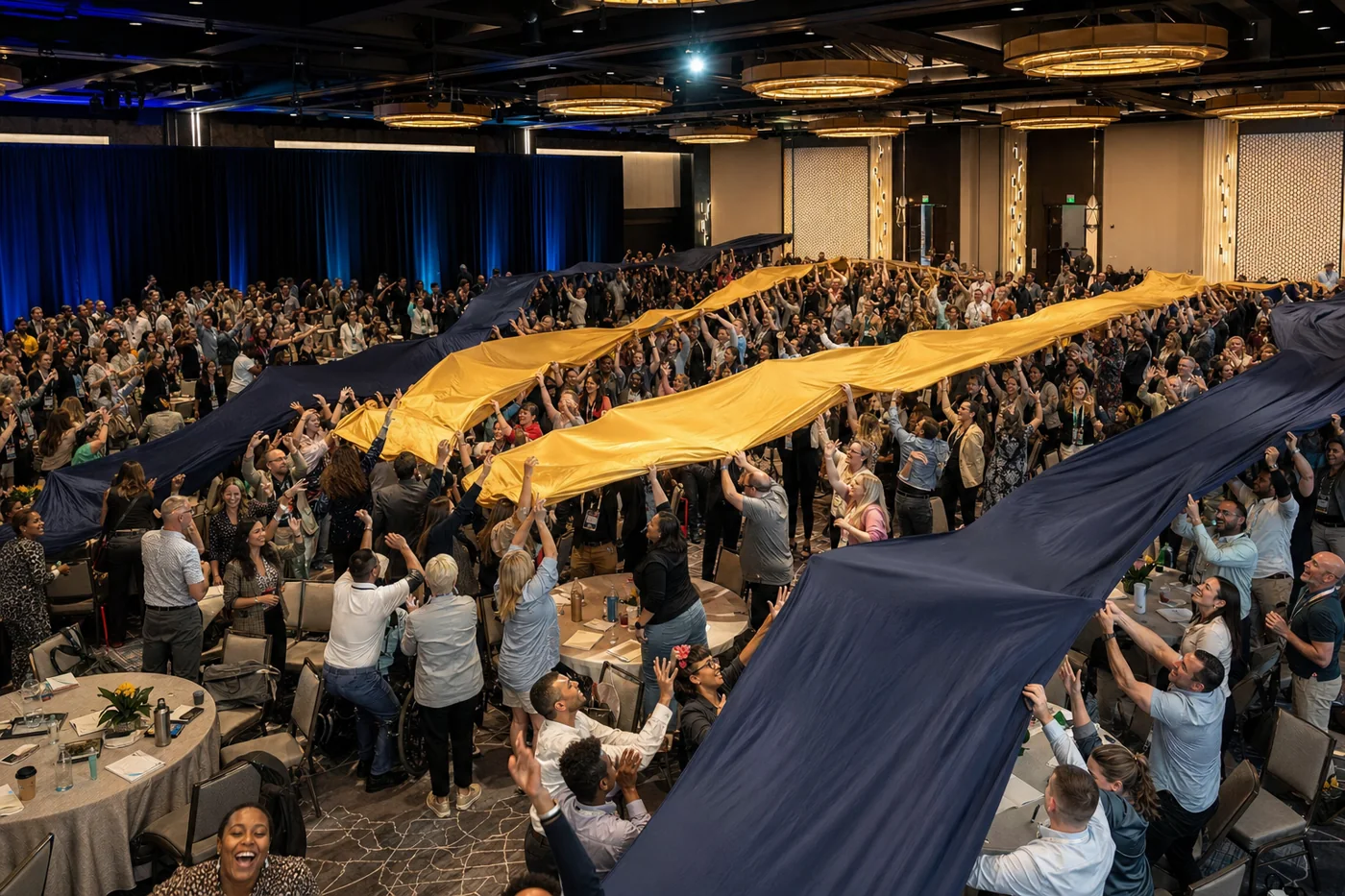 Illustrative concept of a large conference group moving navy and gold fabric together.